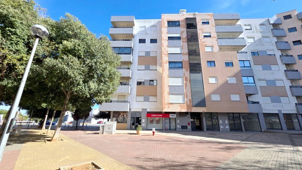 Fachada de prédio de apartamentos com varandas e rés-do-chão comercial, apartamento T3 em Portimão